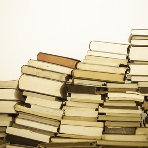 Assortment of used books leaning against wall